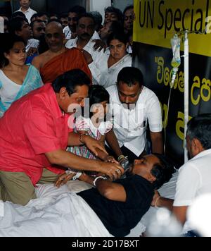 sri-lankan-president-mahinda-rajapaksa-l-gives-coconut-water-to-construction-minister-wimal-weerawansa-ending-his-hunger-strike-protest-against-the-united-nations-war-crimes-panel-at-the-entrance-of-the-un-headquarters-in-colombo-july-10-2010-nine-nations-and-the-european-union-on-friday-warned-sri-lanka-its-handling-of-a-protest-led-by-weerawansa-against-a-un-war-crimes-panel-could-threaten-its-international-standing-reutersandrew-caballero-reynolds-sri-lanka-tags-politics-crime-law-civil-unrest-2d17bxt.jpg