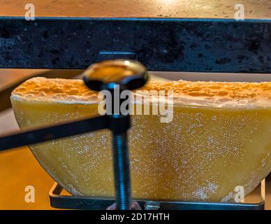 Raclette cheese half. Workshop in the Valais homeland of raclette Turtmann-Unterems, Switzerland Stock Photo