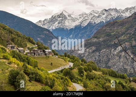 Hike over the vine trail from Visperterminen to Visp, Valais, Switzerland.Again and again, the view opens up to the 4,000-meter peaks in the Upper Valais. Between Visperterminen and Visp are some small hamlets. From the hamlet of Oberstaden, the Reblehrpfad becomes the Tärbiner Kulturweg (Tärbiner culture trail). Stock Photo