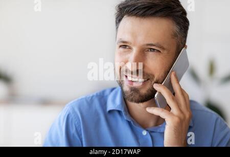 Phone Call. Closeup Shot Of Handsome Millennial Man of Talking On Cellphone Stock Photo