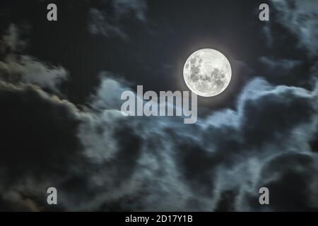 The Moon our satellite companion that illuminates our path during the night on a telescope detailed view with the Lunar craters and seas Stock Photo