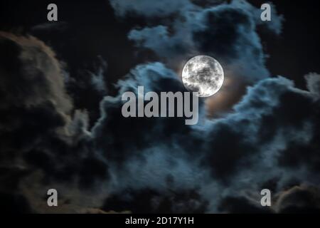 The Moon our satellite companion that illuminates our path during the night on a telescope detailed view with the Lunar craters and seas. An amazing s Stock Photo