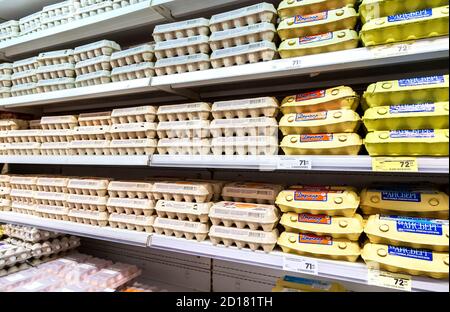 Samara, Russia - November 24, 2019: Different fresh chicken eggs in boxes ready for sale on the shelves at the grocery store Stock Photo