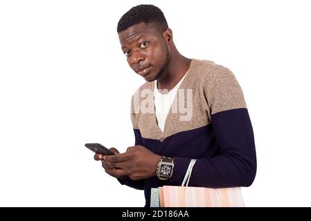 man in gray blue sweater with shopping bags talking on smart-phone isolated on white background Stock Photo