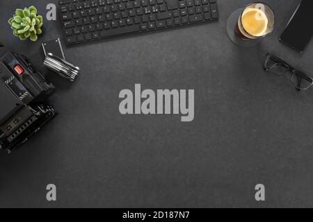 Directly above shot of computer and photographic equipment with coffee on table Stock Photo