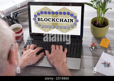 Blockchain technology concept shown on a laptop used by a man Stock Photo