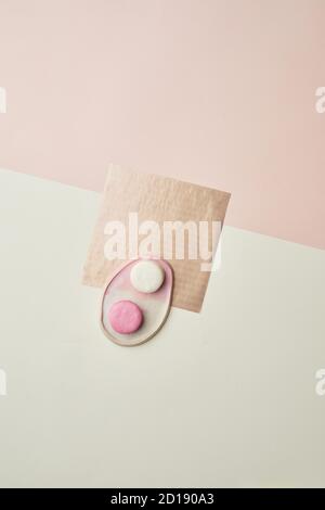 Minimal background image of pastel colored macaroons on ceramic plate laid out in graphic composition, copy space Stock Photo