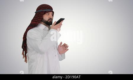 Arabian businessman recording voice message or using voice digit Stock Photo