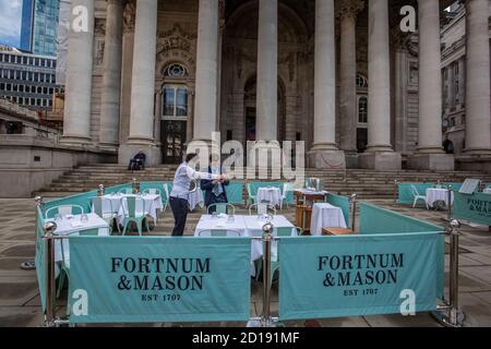 Fortnum & Mason outdoors restaurant is set up outside the Royal Exchange as the coronavirus pandemic continues to keep city workers away, London. Stock Photo