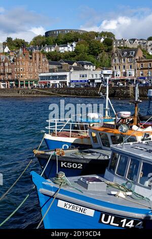The great circle of McCaig’s Folly overlooks the bustling harbour of Oban in Argyll and Bute in the Scottish Highlands Stock Photo
