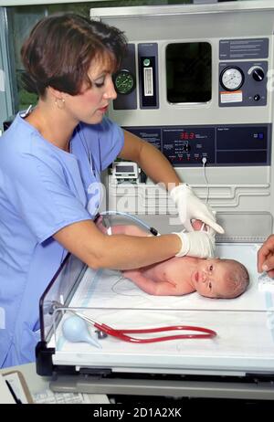 Hospital nurse taking care of the birth of a child Stock Photo