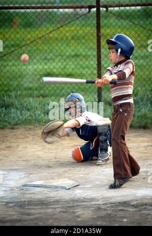 Baseball Softball Action  Little league batter hits ball Stock Photo
