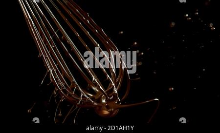 Freeze motion of wire whisk rotating hot melted chocolate, isolated on black background Stock Photo