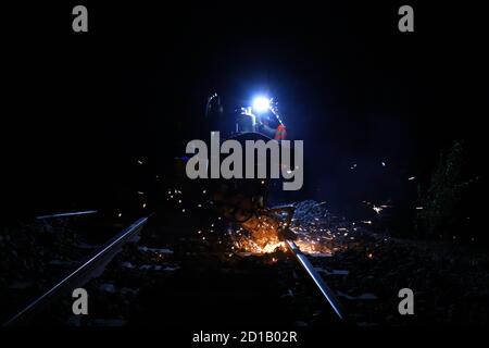 Rail cutting works at night Stock Photo