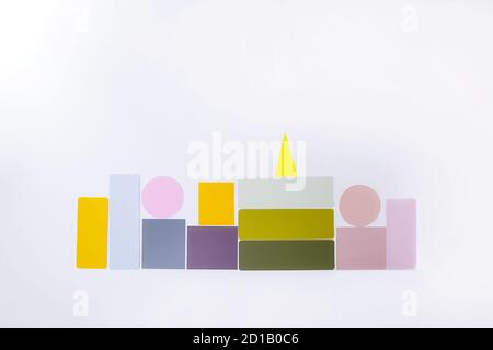 Abstract colorful architectural objects on the white background. Pastel colors geometrical shapes in form of buildings. Creative architecture concept. Stock Photo