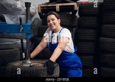 Female engineer is using a press and looking at the camera Stock Photo