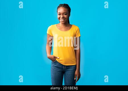 African Millennial Woman With Brackets Smiling Standing Over Blue Background Stock Photo