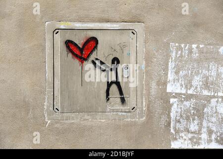 Close-up of a graffiti by Italian street artist Exit Enter (.K) on the electricity meter of an old wall in the city centre of Siena, Tuscany, Italy Stock Photo
