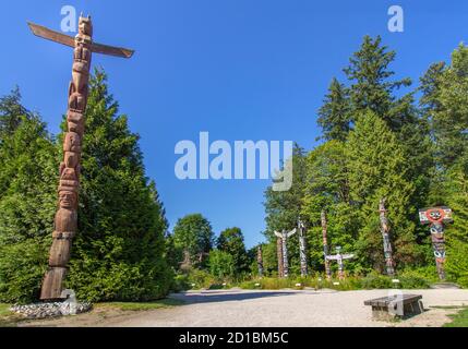 The famous Indigenous / Native artwork in Stanley park, Vancouver, BC. The entrance pole and seven monumental wooden carved and painted totem poles. Stock Photo