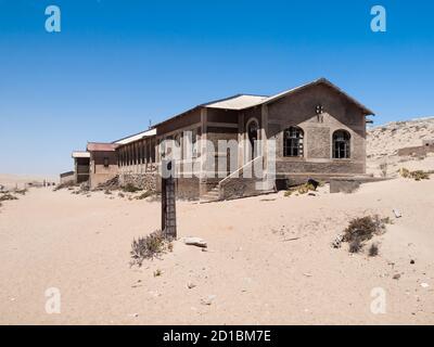 Kolmanskop Ghost Town near old diamond mines in southern Namibia with devasted houses filled with sand. Stock Photo