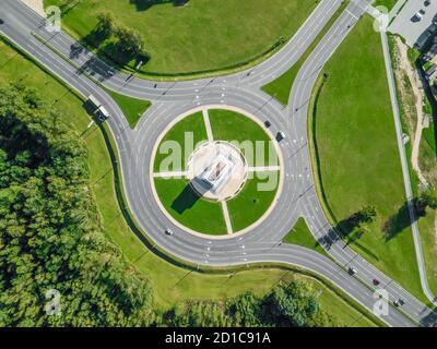 Aerial view of the ring road with a three-way fork on a Sunny summer day. City infrastructure. Beautiful top view of the ring road. Stock Photo