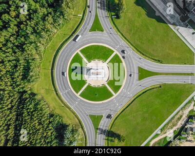 Aerial view of the ring road with a three-way fork on a Sunny summer day. City infrastructure. Beautiful top view of the ring road. Stock Photo