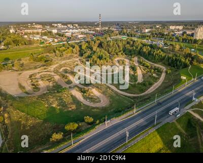 Top view from a drone of a motocross race track on the outskirts of the city, off-road on a Sunny day Stock Photo