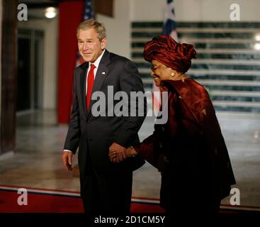 President George W Bush holds hands with family members of victims of ...