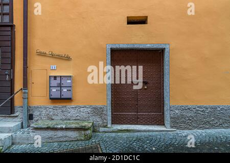 Wooden door of a cantina where food is stored in a cool place. Culinary tour on Lake Lugano in Ticino, Circolo di Carona, Switzerland Stock Photo