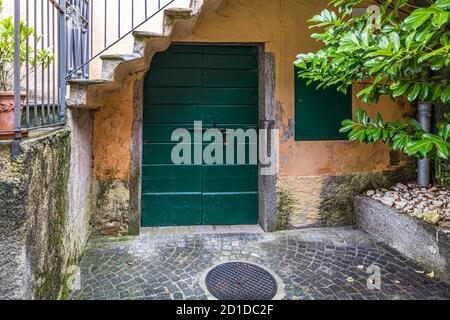 Wooden door of a cantina where food is stored in a cool place. Culinary tour on Lake Lugano in Ticino, Circolo di Carona, Switzerland Stock Photo