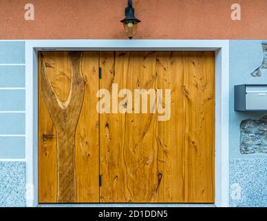 Wooden door of a cantina where food is stored in a cool place. Culinary tour on Lake Lugano in Ticino, Circolo di Carona, Switzerland Stock Photo