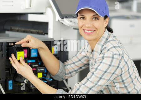 technician is checking and changing the printer equipment cartridges Stock Photo