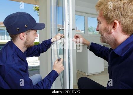 workers fitting a window Stock Photo
