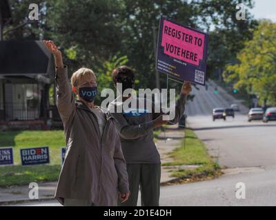 Dayton, OH, USA. 5th Oct, 2020. Debra Dunlop and Valerine Lee wave to drivers to encourage those who have yet to register to do so at the nearby voter registration site. Credit: Sue Dorfman/ZUMA Wire/Alamy Live News Stock Photo