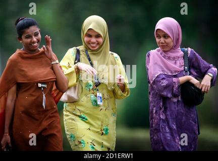 Malay And Indian Women Share A Light Moment As They Leave Office After Work In Putrajaya Outside Kuala Lumpur In This January 3 2007 File Photo As Malaysia Marks 50 Years Of