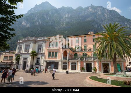 RIVA DEL GARDA, ITALY - JUNE 6, 2019: The square with the Alps in the backgound. Stock Photo