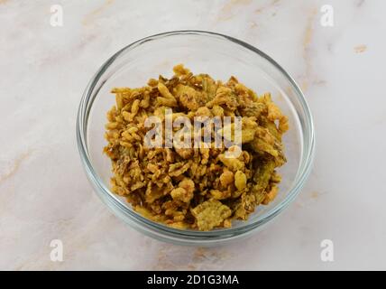 Crispy jalapeno pepper topping in glass ingredient bowl on table Stock Photo