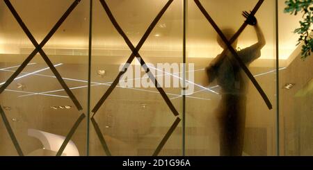 A Man Sticks Tape On A Glass Door To Prepare For Typhoon Sinlaku In Taipei September 12 2008 The Typhoon Carrying Gusts Of More Than 200 Kph 120 Mph Was Churning Towards