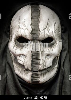 Death Hood Mask With Face Ripped Down The Middle Isolated on Black Background Stock Photo
