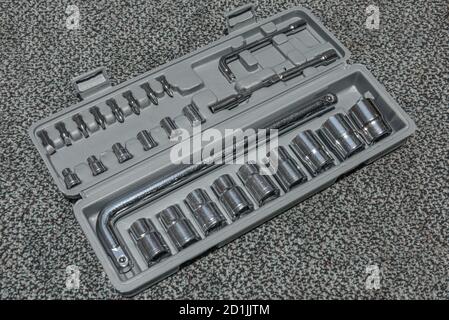 Set of the wrench in the opened toolbox on the carpet Stock Photo