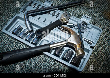 Set of the wrench in the opened toolbox with a hammer on the carpet Stock Photo