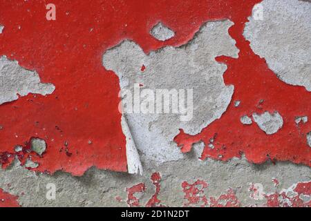 Peeled paint of old red wall, texture or background Stock Photo