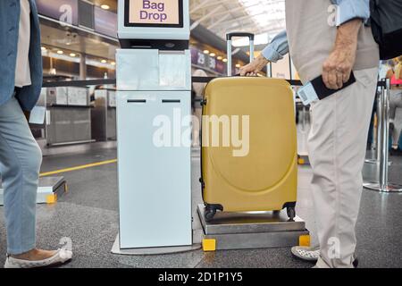 Two Caucasian passengers using a self-service unit Stock Photo
