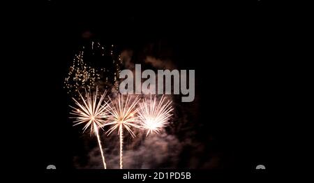 Burning sparklers on black background. Small fireworks giving off sparks of fire. Sparks explosion. During Armada exhibition in France Stock Photo