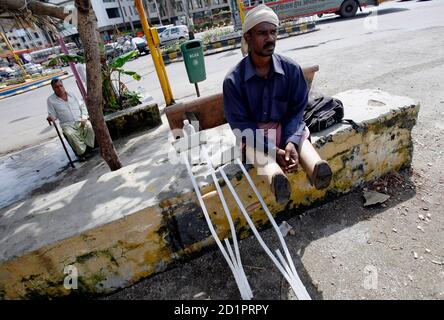 Indian man on crutches at Mumbai Marathon, Maharashtra, India, Asia ...