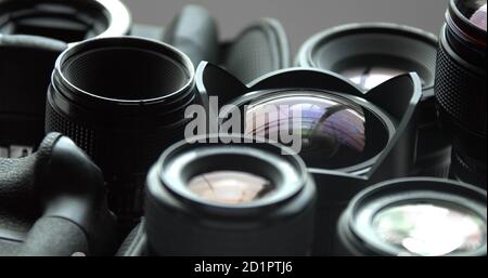 Several DSLR camera lenses on a grey background Stock Photo