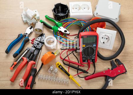 Tools for electrician needs: shocket multimeter, voltage testers, wire strippers, pliers, Stock Photo