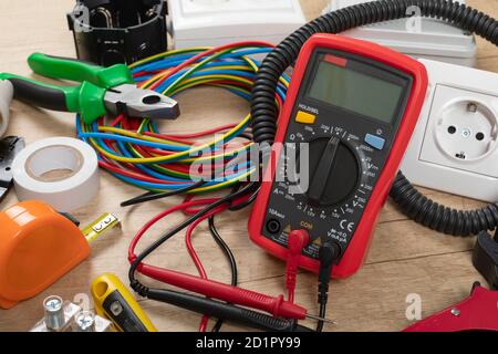 Tools for electrician needs: shocket multimeter, voltage testers, wire strippers, pliers, Stock Photo