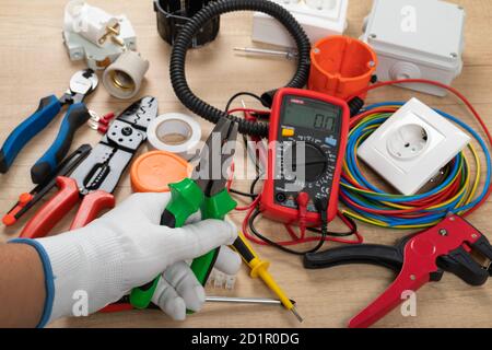 Tools for electrician needs: shocket multimeter, voltage testers, wire strippers, pliers, Stock Photo