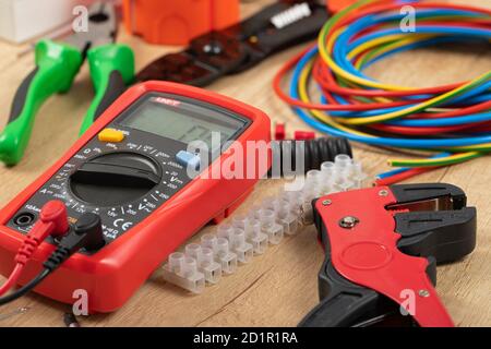 Tools for electrician needs: shocket multimeter, voltage testers, wire strippers, pliers, Stock Photo